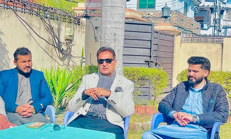PML-N regional Secretary General and former AJK senior minister Chaudhry Tariq Farooq (centre) speaks to media at his residence. &mdash; photo via author