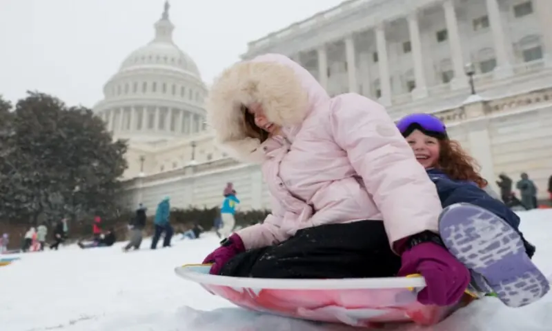 Children sled near the US Capitol building as a major winter storm spreads across a large swath of the United States, in Washington, DC, US, January 25, 2026. &mdash; Reuters/Jonathan Ernst