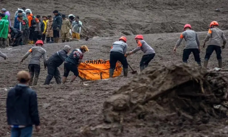 Indonesian rescue members carry a body bag containing the remains of a victim from the site of a landslide after it hit Pasirlangu village, West Bandung, West Java province, Indonesia, January 24, 2026. &mdash; Reuters