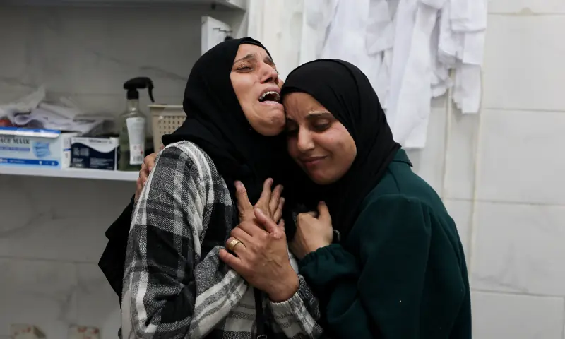 Mourners react during the funeral of Palestinians who, according to medics, were killed by Israeli strikes on Saturday, at Al-Shifa Hospital in Gaza on January 24, 2026. &mdash; Reuters
