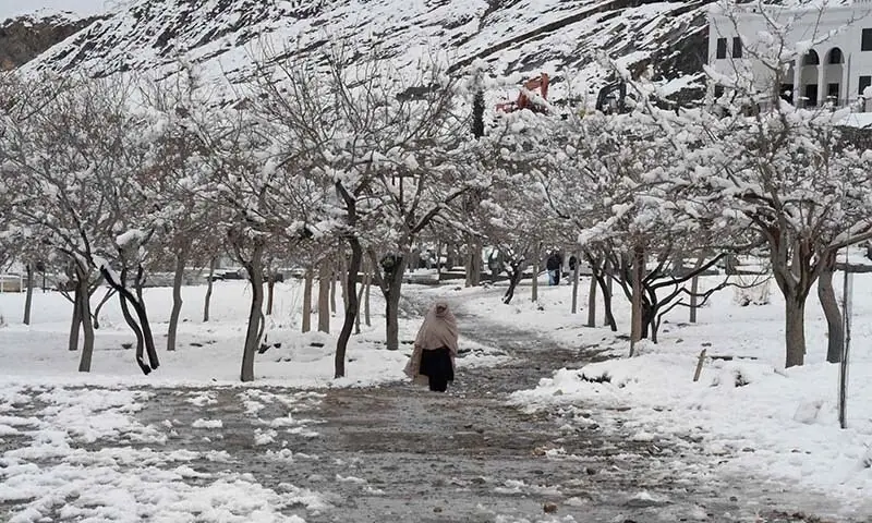 A woman walks in a snowy region of AJK in this 2020 file photo. — AFP/File A woman walks in a snowy region of AJK in this 2020 file photo. — AFP/File