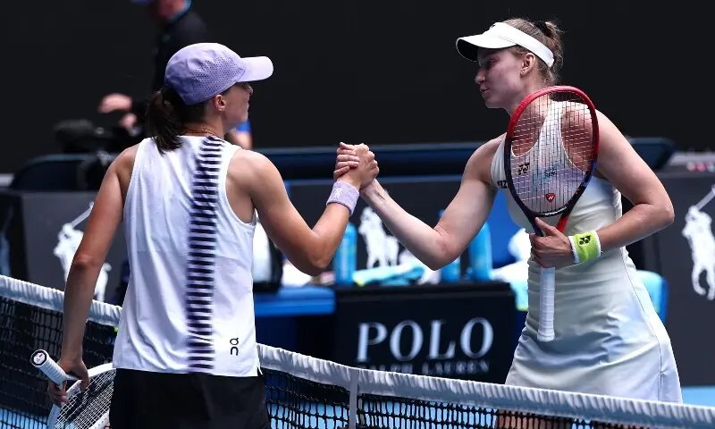 Kazakhstan’s Elena Rybakina (R) shakes hands with Poland’s Iga Swiatek after their women’s singles quarter-final match on day eleven of the Australian Open tennis tournament in Melbourne on January 28, 2026. —AFP