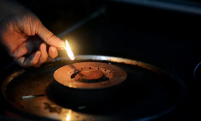 Undated image shows a person lighting a stove. &mdash;White Star/File