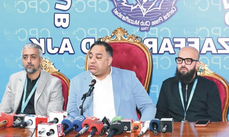 Flanked by the representatives of a UK based charity, British MP Imran Hussain (centre) speaks at a press conference in Muzaffarabad on January 28. &mdash; photo by Tariq Naqash