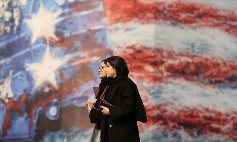 People walk past an anti-US billboard in Tehran, Iran, January 26. &mdash; Reuters/File