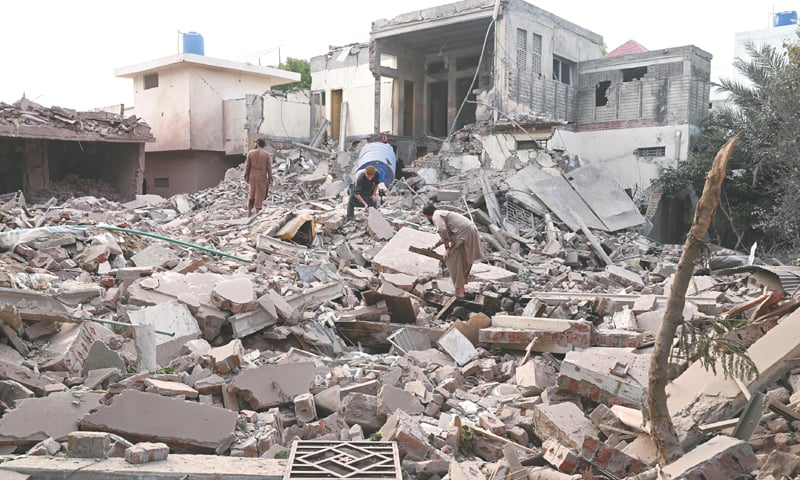 PEOPLE dig through the rubble of a destroyed building in Muridke, Punjab after an Indian strike during the May war. — White Star/File PEOPLE dig through the rubble of a destroyed building in Muridke, Punjab after an Indian strike during the May war. — White Star/File