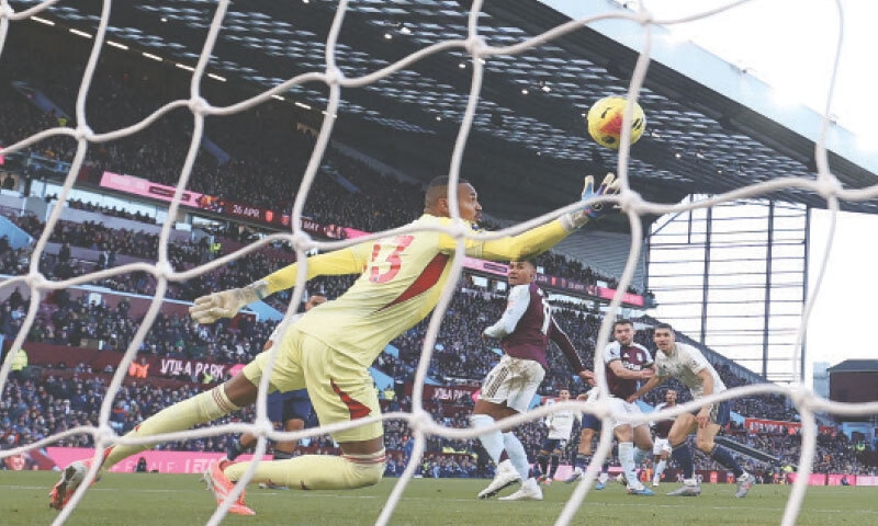 BIRMINGHAM: Aston Villa&rsquo;s John McGinn (second R) watches his shot beat Nottingham Forest goalkeeper John Victor during their Premier League match at Villa Park on Saturday.&mdash;AFP