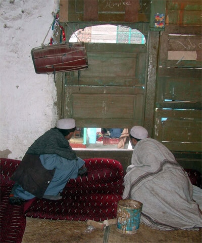In Peshawar’s Dabgari Bazaar, musicians traditionally kept their balcony windows open so passers-by could see and hire them. During the MMA provincial government’s campaign against music, pressure from authorities forced these windows shut. In this image from 2003, two musicians cautiously peer onto the street — a quiet moment reflecting how fear and regulation pushed a once public art into the shadows