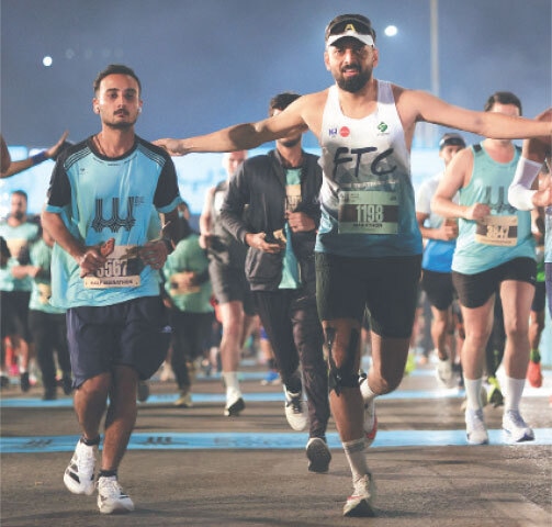   PARTICIPANTS in action during the BYD Karachi Marathon at the Abdul Sattar Edhi Avenue on Sunday.  
