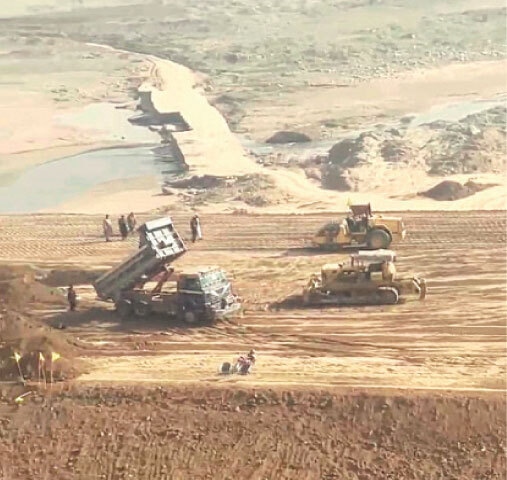  Work underway to level land for the spillway and bed of the dam. 