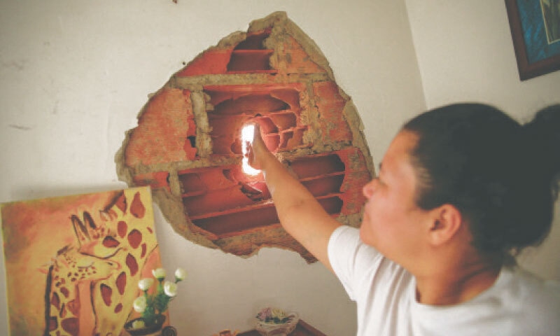 CARACAS: A woman shows damage to a residential building following a US raid on Venezuela to capture its President Nicolas Maduro and his wife Cilia Flores.&mdash;Reuters