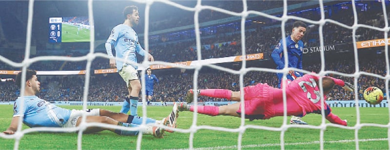 MANCHESTER: Chelsea&rsquo;s Enzo Fernandez (R) scores past Manchester City goalkeeper Gianluigi Donnarumma during their Premier League match at the Etihad Stadium.&mdash;Reuters