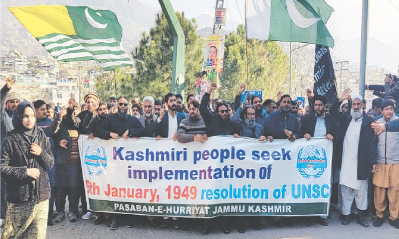 Carrying large flags of Azad Kashmir and Pakistan, Kashmiri activists chant pro-freedom and anti-India slogans during a march along a main thoroughfare in Muzaffarabad on Monday to mark the Right to Self-Determination Day. &mdash; Dawn