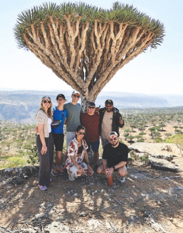 Tourists gather for a group photo under a dragon blood tree in Yemen’s Socotra Island.—Reuters