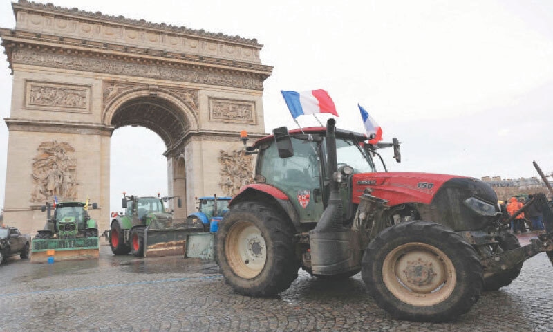 TRACTORS are parked in front of the Arc de Triomphe during a demonstration by farmers in Paris.—AFP TRACTORS are parked in front of the Arc de Triomphe during a demonstration by farmers in Paris.—AFP