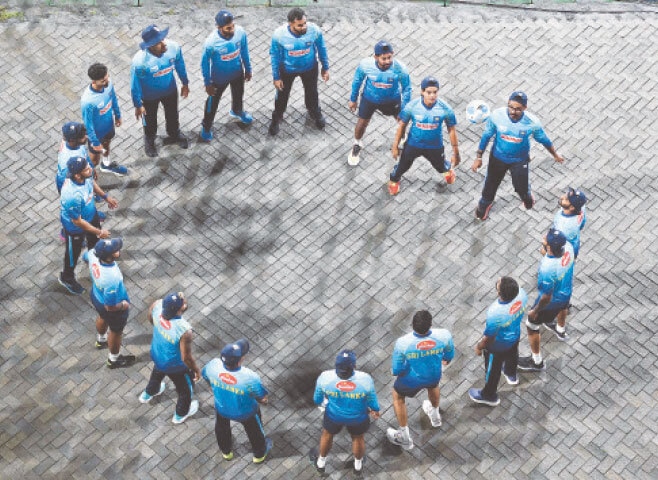 DAMBULLA: Sri Lankan players warm up during a rain delay in the second Twenty20 International against Pakistan at the Rangiri Dambulla International Stadium on Friday.—AFP