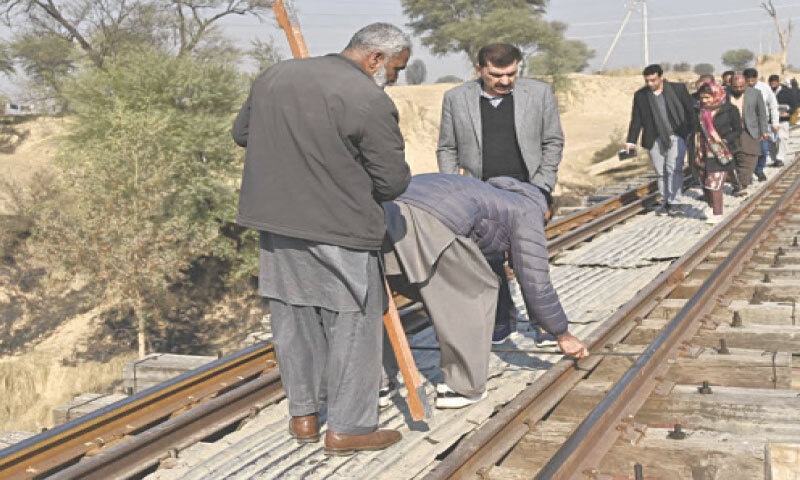 Railway officials conduct a safety audit of a bridge on Taxila-Havelian route on Saturday. &mdash; Dawn