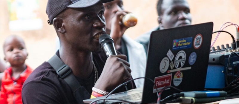 VJ CB performing at the Kampala Slum Mobile Cinema, 2024 | Roja Matelja Mugabirwe/Kampala Slum Mobile Cinema