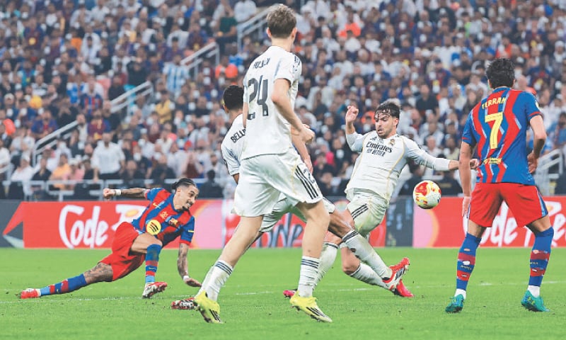 JEDDAH: Barcelona&rsquo;s Raphinha (L) scores against Real Madrid during the Spanish Super Cup final at the King Abdullah Sports City Stadium.&mdash;Reuters