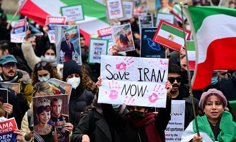 MILAN: Anti-Iran regime protesters chant slogans during a rally outside the US consulate.&mdash;AFP