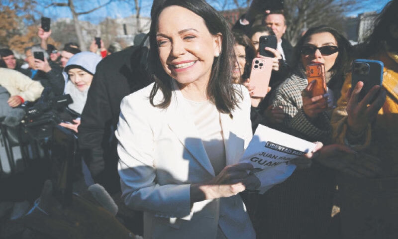 Venezuelan opposition leader Maria Corina Machado greets supporters outside the White House following a meeting with President Donald Trump.&mdash;AFP