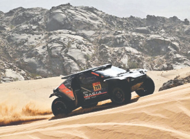 Dacia Sandriders&rsquo;s Qatari driver Nasser al-Attiyah and co-pilot Fabian Lurquin of Belgium compete during the 12th stage of the Dakar Rally, a 409km distance from Al Henakiyah to Yanbu, on Friday.&mdash;AFP