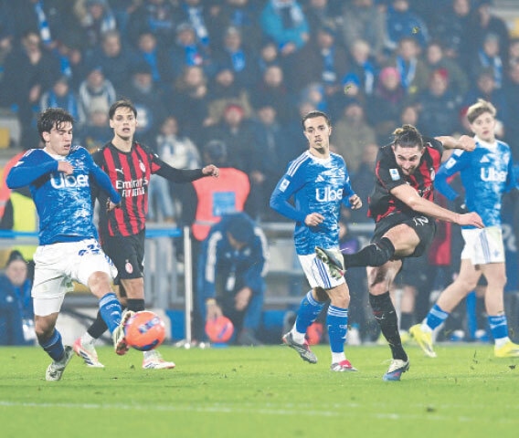 COMO: Adrien Rabiot (second R) of AC Milan shoots to score against Como during their Serie A match at Stadio Giuseppe Sinigaglia.—Reuters