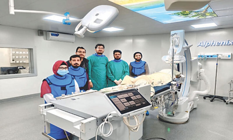 A team of interventional cardiologists and staff pose after successfully conducting the first percutaneous coronary interventions at the newly established cardiac catheterisation facility in Jhelum District Hospital. — Dawn A team of interventional cardiologists and staff pose after successfully conducting the first percutaneous coronary interventions at the newly established cardiac catheterisation facility in Jhelum District Hospital. — Dawn