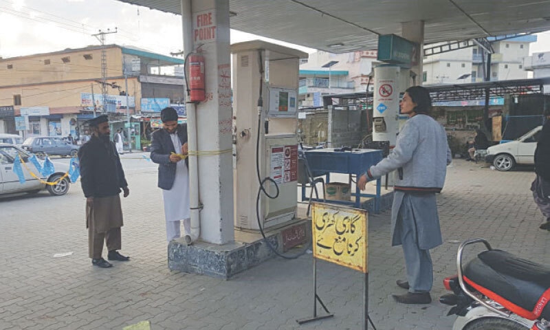 A worker closes a CNG station in Mansehra on Saturday. — Dawn A worker closes a CNG station in Mansehra on Saturday. — Dawn