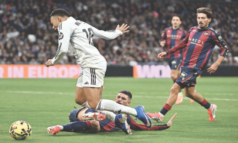 MADRID: Real Madrid&rsquo;s Kylian Mbappe is fouled by Adrian De La Fuente of Levante during their La Liga match at Santiago Bernabeu on Saturday.&mdash;AFP