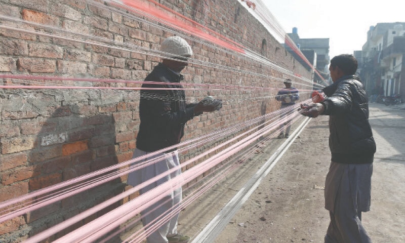 Workers in Lahore prepare kite strings in accordance with new regulations for the Basant festival, set to return to the city next month after a ban of nearly two decades.&mdash;Murtaza Ali