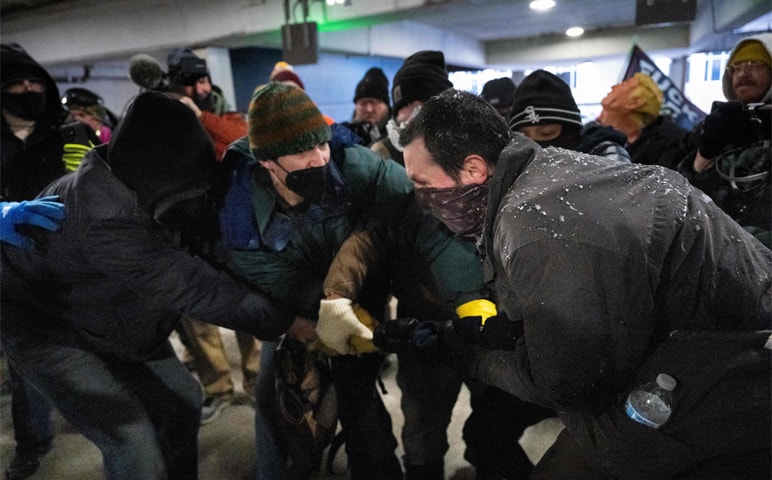  PROTESTERS scuffle with an ICE supporter who was in downtown for ‘Americans Against Islamification’ rally.—AFP 