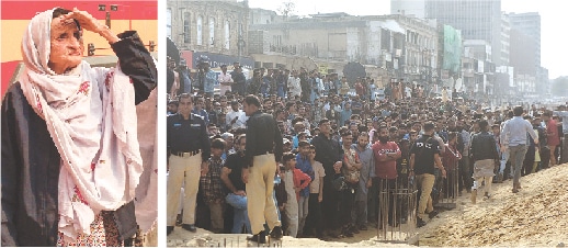 An elderly woman, who lost three family members in the massive Gul Plaza blaze, waits for the completion of a search operation. Policemen (right) stop a large number of people, including traders, at a safer distance from the burning building.&mdash;Reuters / Fahim Siddiqi / White Star