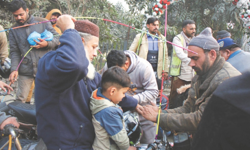 Safety rods being installed on motorcycles outside the Greater Iqbal Park. &mdash; White Star
