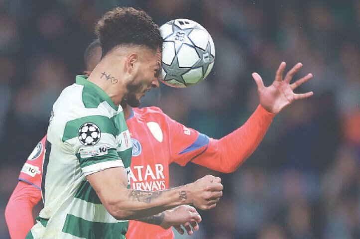 LISBON: Sporting Lisbon&rsquo;s Luis Suarez heads to score during the match against Paris St Germain at the Jose Alvalade Stadium.&mdash;AFP