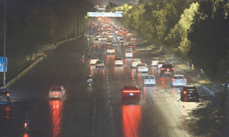 Motorists head to their destinations on the Islamabad Expressway during rainy weather on Thursday. — Photo by Mohammad Asim Motorists head to their destinations on the Islamabad Expressway during rainy weather on Thursday. — Photo by Mohammad Asim