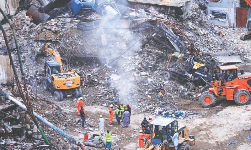 The use of heavy machinery for debris removal has sparked fears of desecration of the remains of Gul Plaza fire victims.&mdash;Shakil Adil / White Star