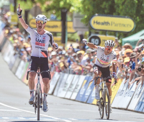 UAE Team Emirates XRG’s Australian rider Jay Vine (L) celebrates after winning the second stage of the Tour Down Under as his team-mate Jhonatan Narvaez of Ecuador reacts on Thursday.—AFP