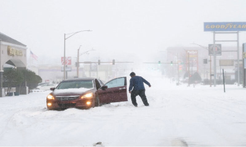 A car is stuck in the snow in Little Rock, Arkansas.&mdash;AFP