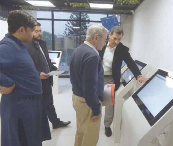 A PAKC officer briefs a visitor about digital services offered at the centre.