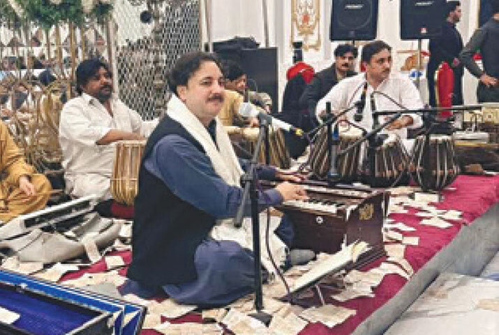 A Singer performs at a musical concert in Peshawar. &mdash; Dawn