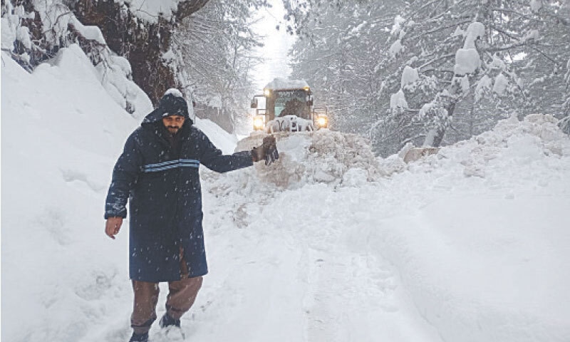A machine clears Shogran Road in Balakot, Mansehra, on Tuesday. — Photo by Nisar Ahmad Khan A machine clears Shogran Road in Balakot, Mansehra, on Tuesday. — Photo by Nisar Ahmad Khan