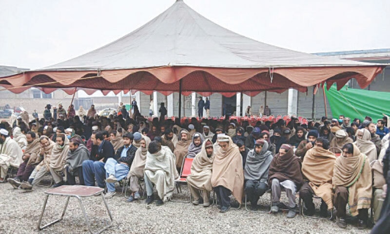 BARA (Khyber district): Exhausted displaced persons from the Tirah valley wait under a tent at a newly established registration centre in the Alamgudar locality.&mdash;Dawn