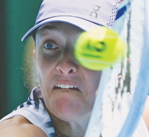 POLAND’S Iga Swiatek hits a return to Kazakhstan’s Elena Rybakina during their quarter-final.—AFP