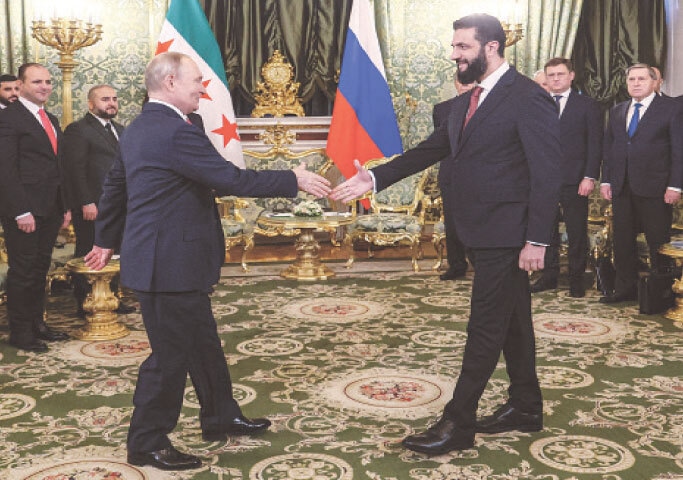 RUSSIAN President Vladimir Putin shakes hands with his Syrian counterpart Ahmed al Sharaa at the Kremlin.&mdash;Reuters