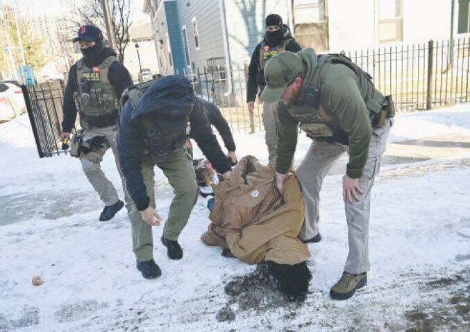  Security personnel detain a protester in Minneapolis.&mdash;AFP 
