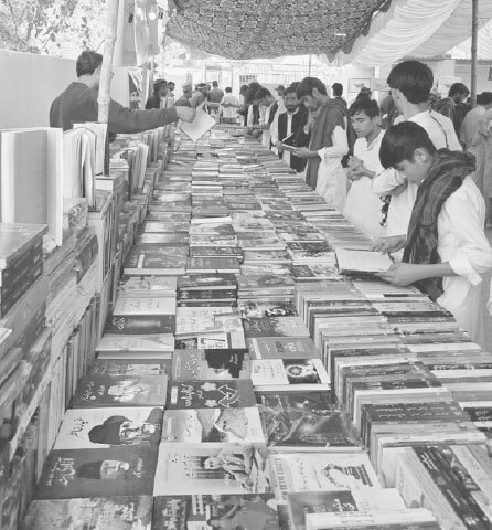 Visitors browse through books on display at the Gwadar fair.—Photo by the writer