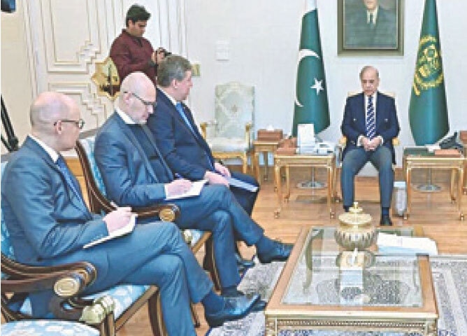 EU envoy Raimundas Karoblis speaks to PM Shehbaz Sharif during their meeting at the PM Office.&mdash;APP