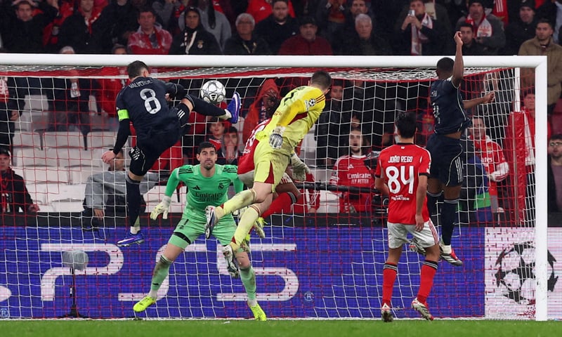 LISBON: Benfica goalkeeper Anatoliy Trubin (C) heads to score against Real Madrid during their Champions League match at Estadio da Luz.—Reuters LISBON: Benfica goalkeeper Anatoliy Trubin (C) heads to score against Real Madrid during their Champions League match at Estadio da Luz.—Reuters