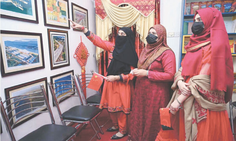 Visitors take interest in pictures displayed at an exhibition held at China Window, Peshawar, on Friday to mark 75th anniversary of Pak-China friendship. &mdash; APP